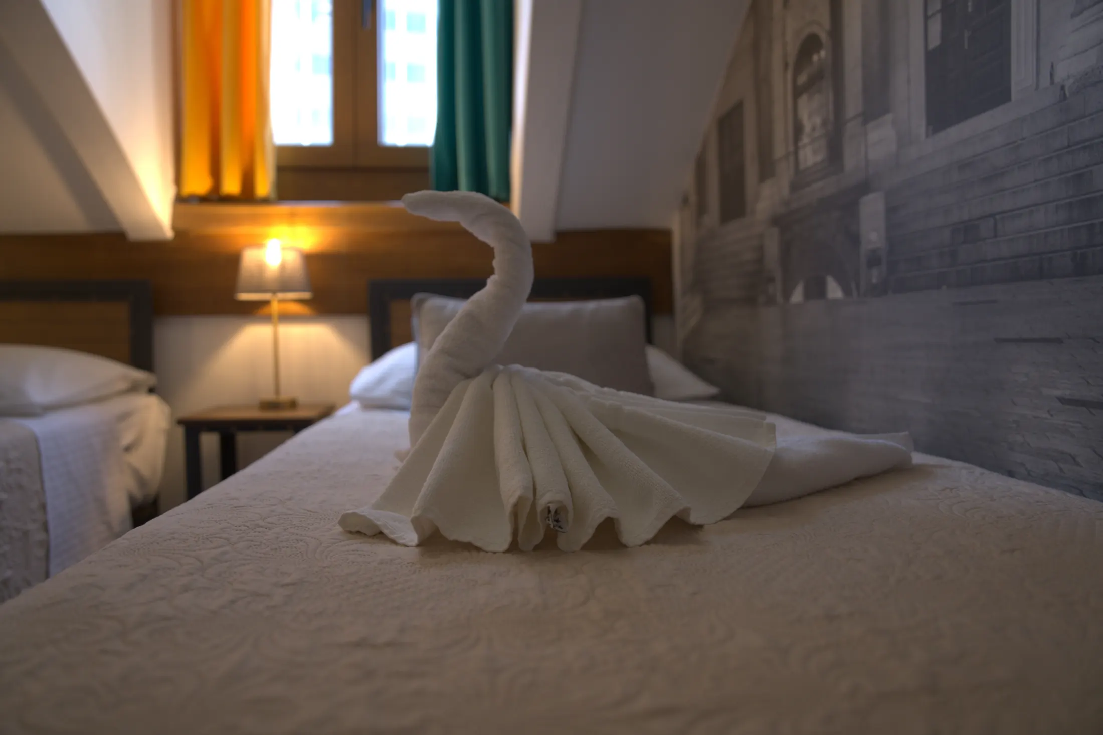 The bed by the window beneath the sloping attic ceiling, Hotel Villa Diana, Lučac, Split