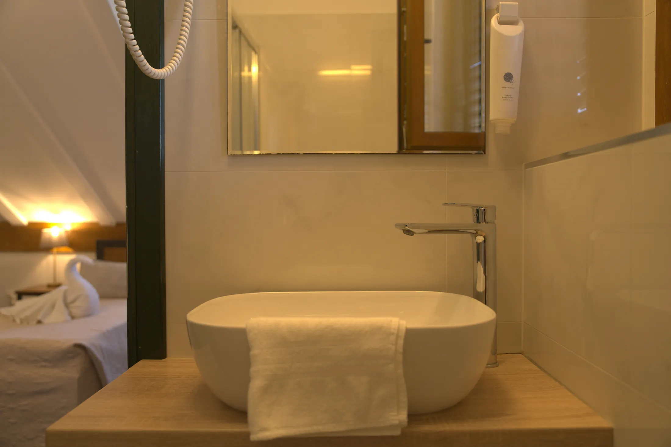 The washbasin with mirror and hairdryer, looking through to the room, Hotel Villa Diana, Lučac, Split