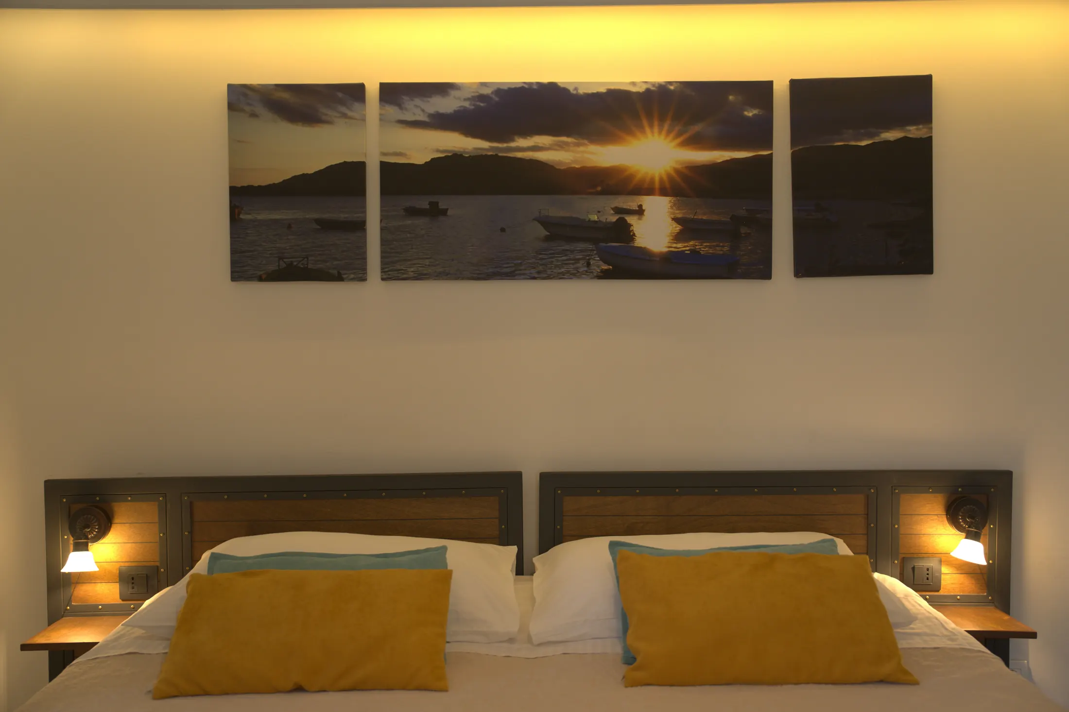 The headboard with reading lamps and a sunset seascape above the bed, Hotel Villa Diana, Lučac, Split