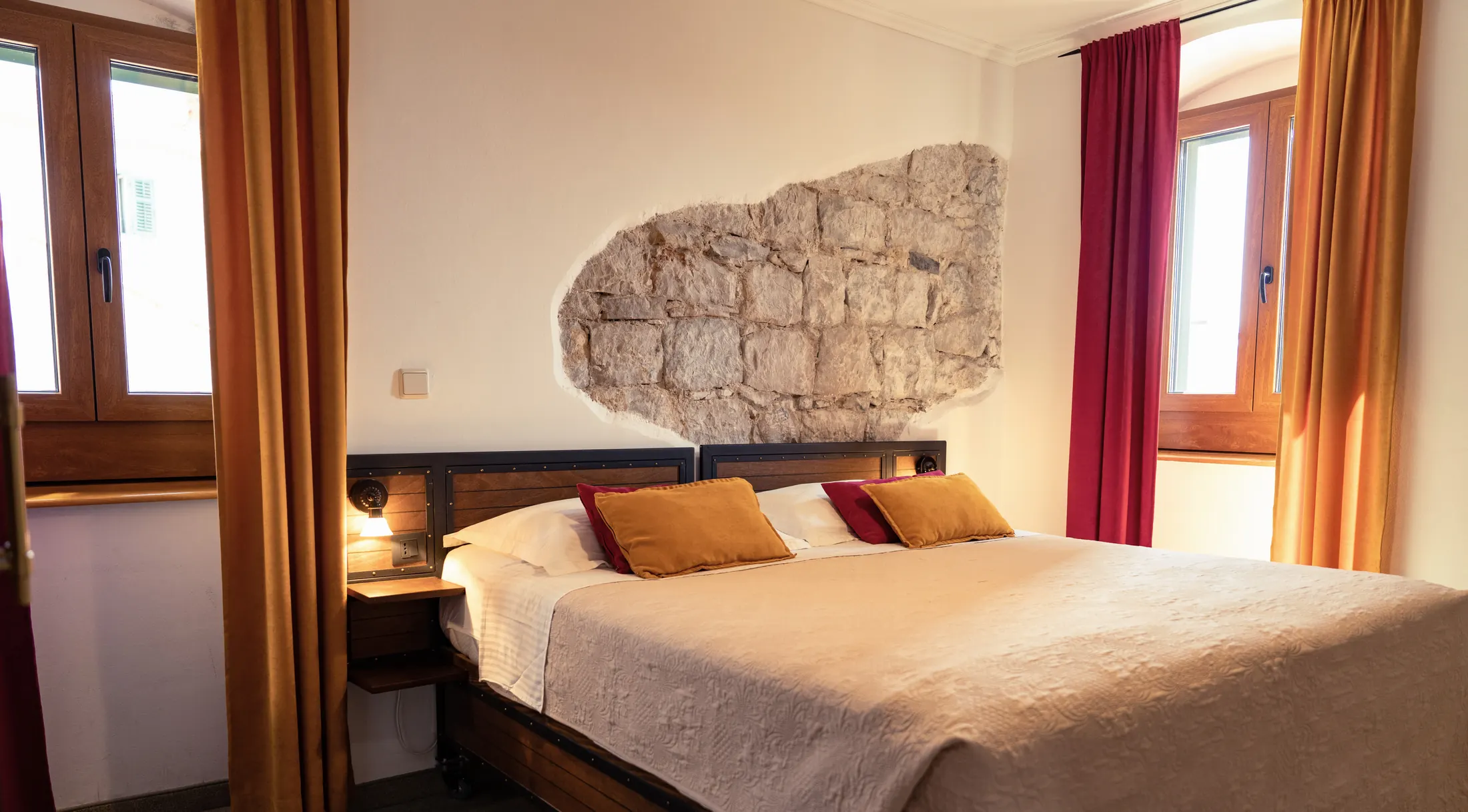 A Standard double room with two windows and a stone wall above the bed, Hotel Villa Diana, Lučac, Split